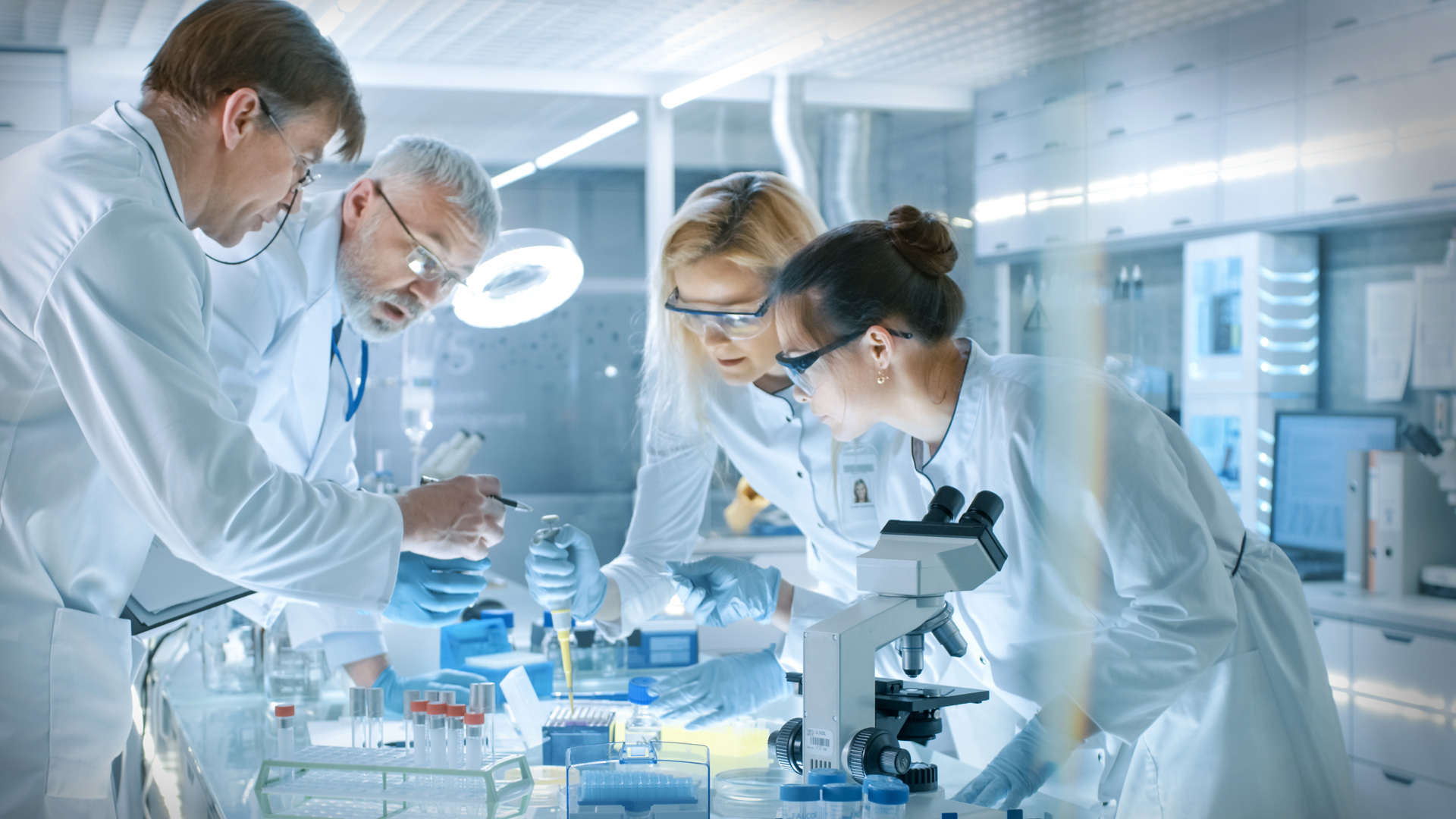 A group of people working and taking together in a modern laboratory environment